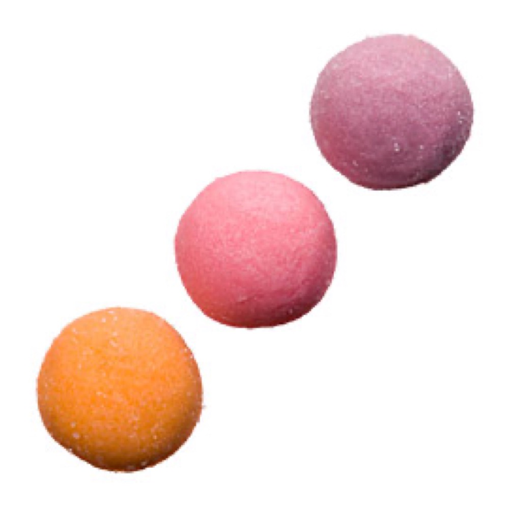 Three multicolored, sugar-coated balls, one orange, one pink, and one purple, against a white background.