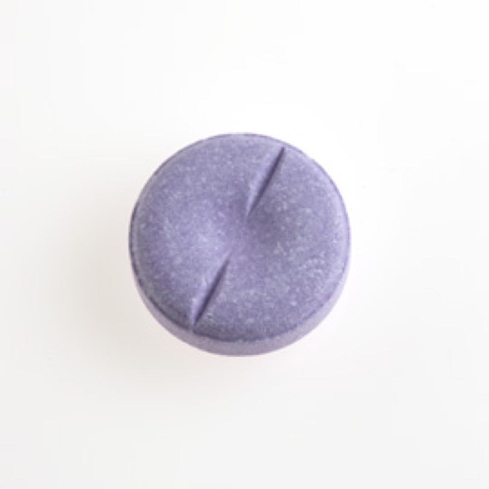 One circular, purple-colored lozenge, with two lines imprinted across the outer edges.