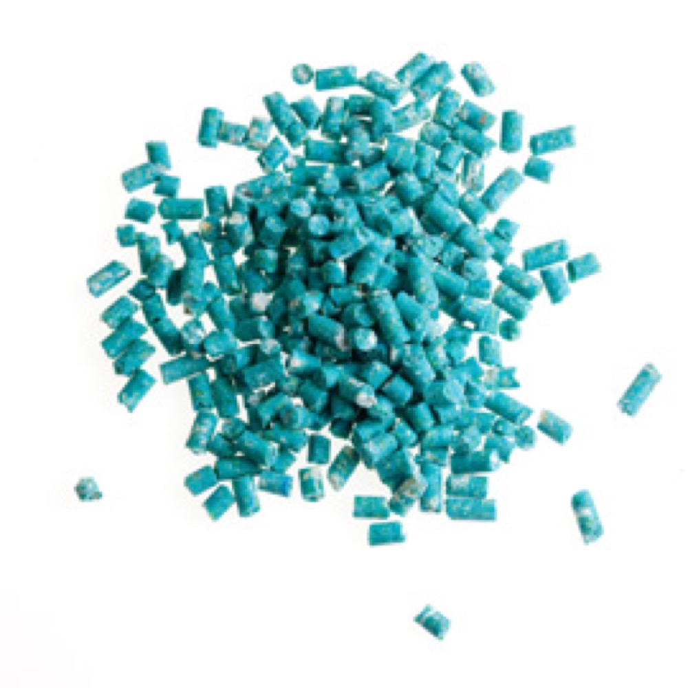A pile of blue bead-like objects, arranged on a clean white surface..